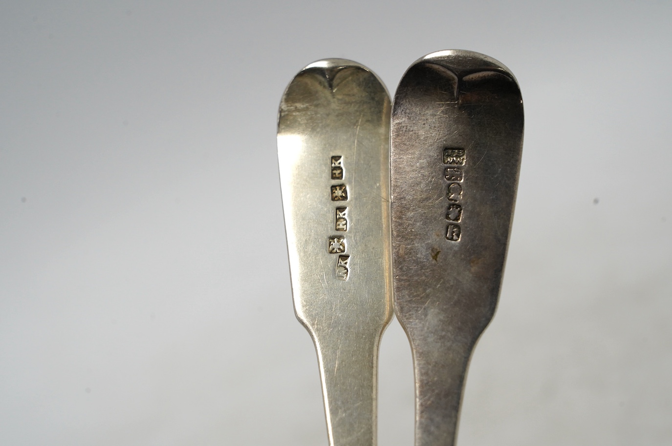 A George IV Scottish provincial silver fiddle pattern table spoon by Robert Keay I, Perth, circa 1825, 22.1cm, together with a George IV provincial silver fiddle pattern table spoon by Barber & Whitwell, York, 1821. Cond